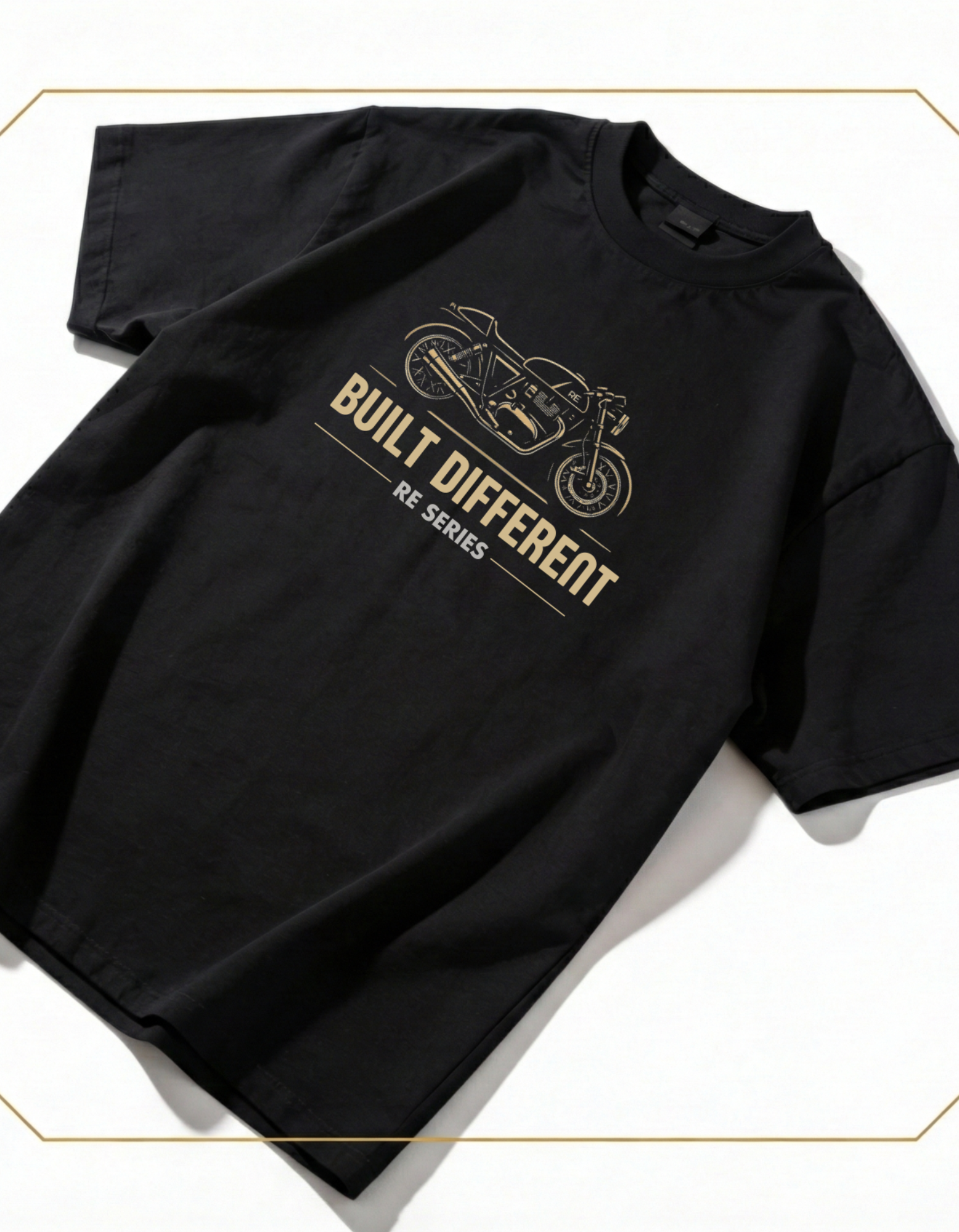 Flat lay of BUILT DIFFERENT oversized t-shirt showing complete café racer 
motorcycle design with gold technical line work on white background
